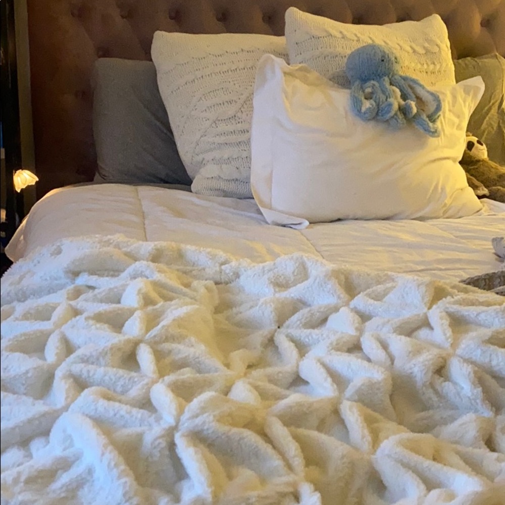 Medium sized, white, soft throw blanket